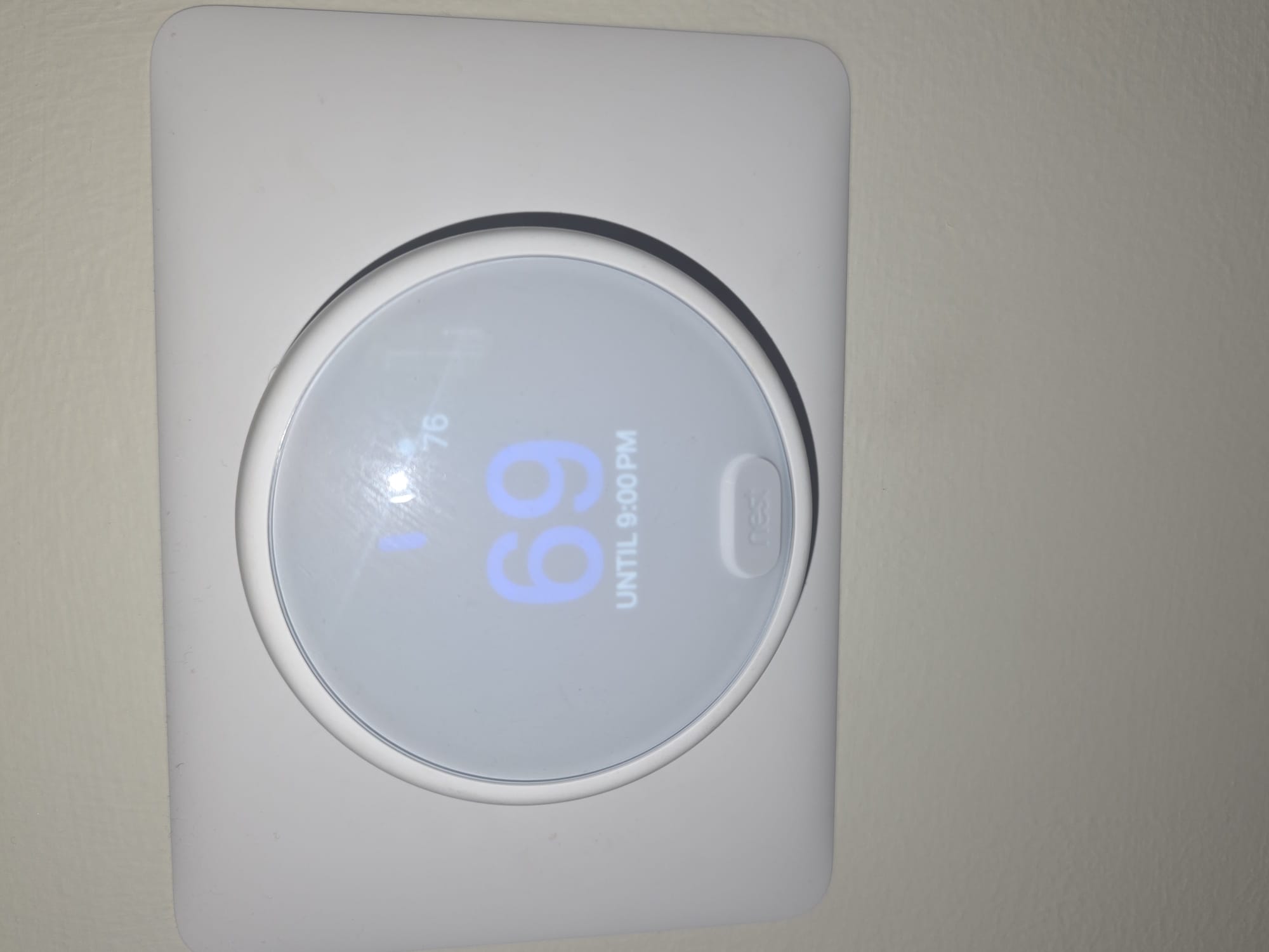 Modern smart thermostat on wall