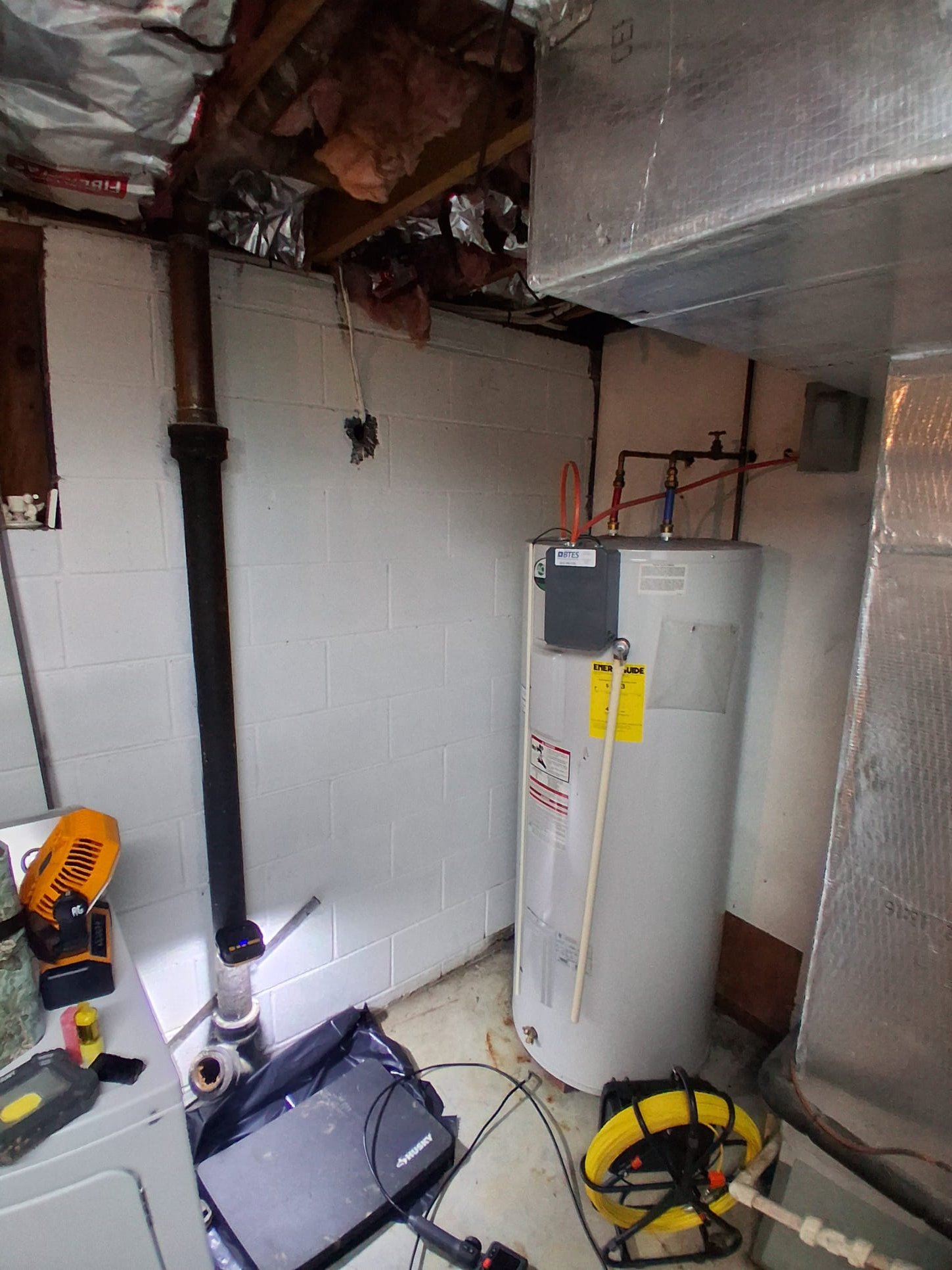 Fresh hot and cold water lines connected to a new water heater.
