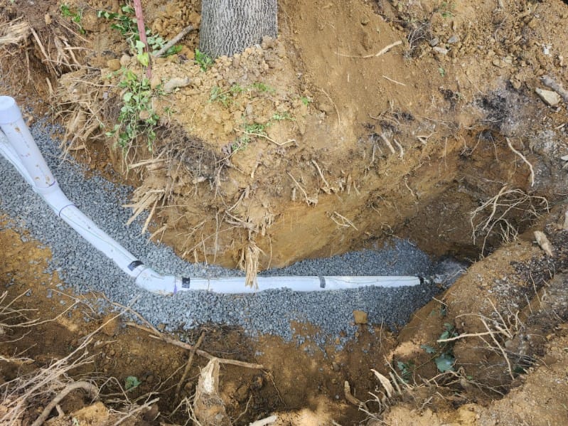 New PVC pipe laid on gravel bed