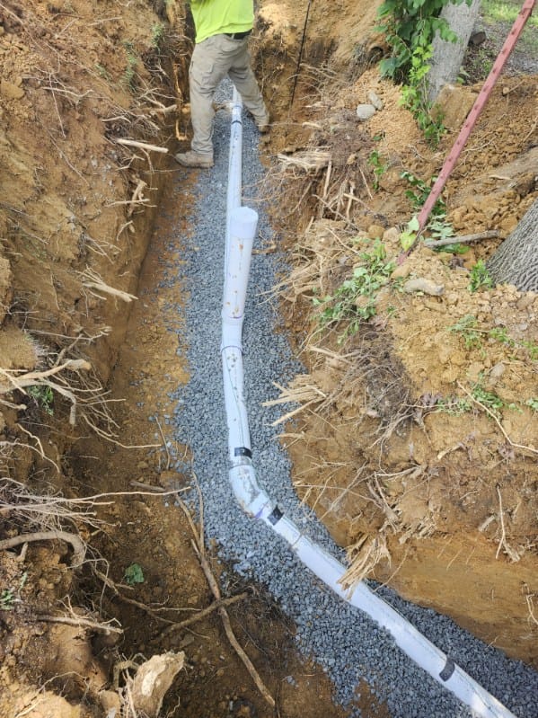 Technician preparing to backfill trench