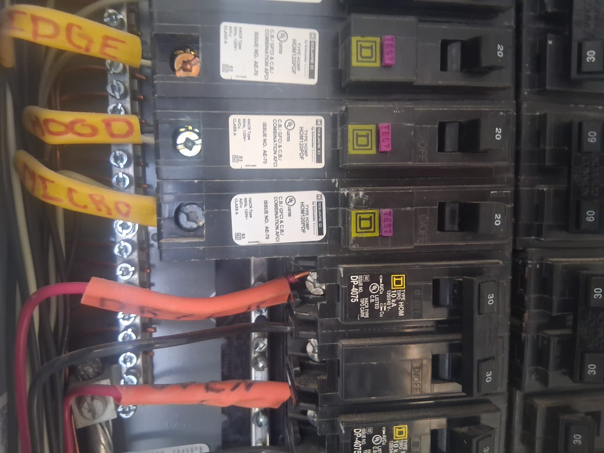 A newer-looking residential electrical panel with labeled breakers