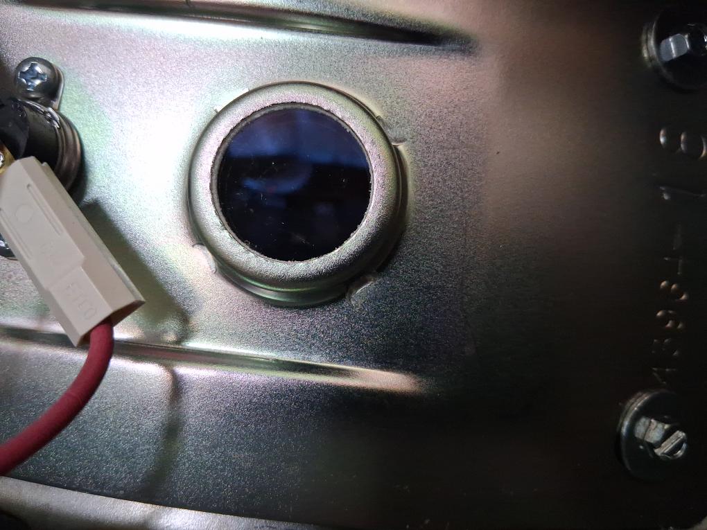 Blue burner flame visible through the inspection window