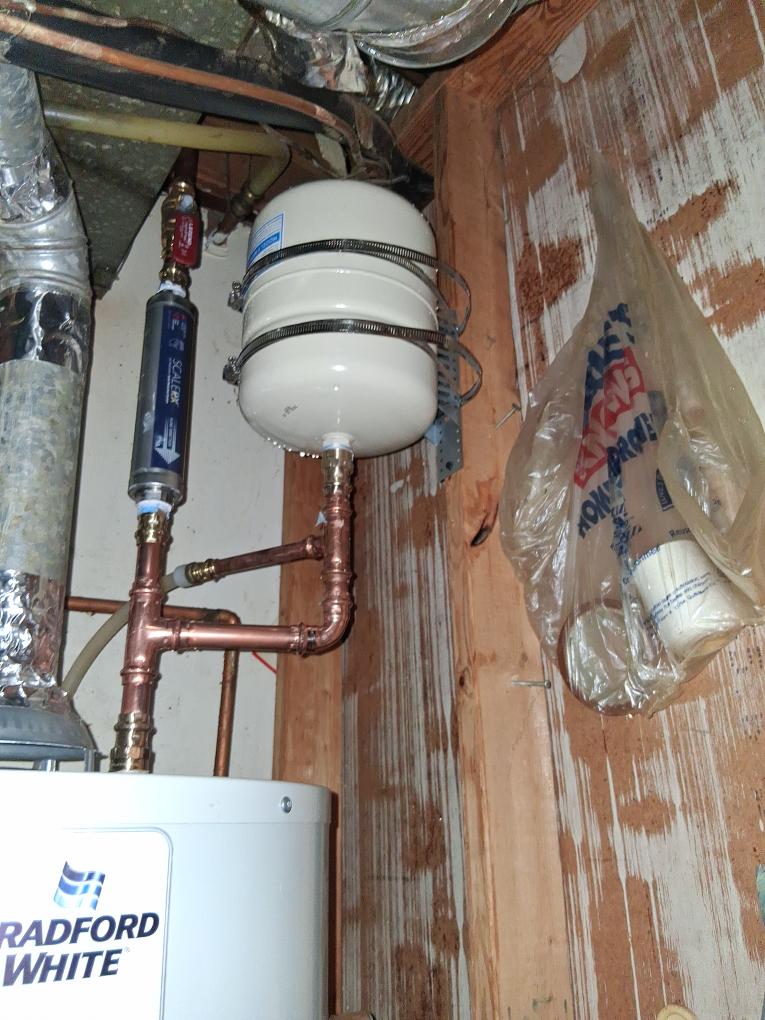 New expansion tank and copper piping above the water heater