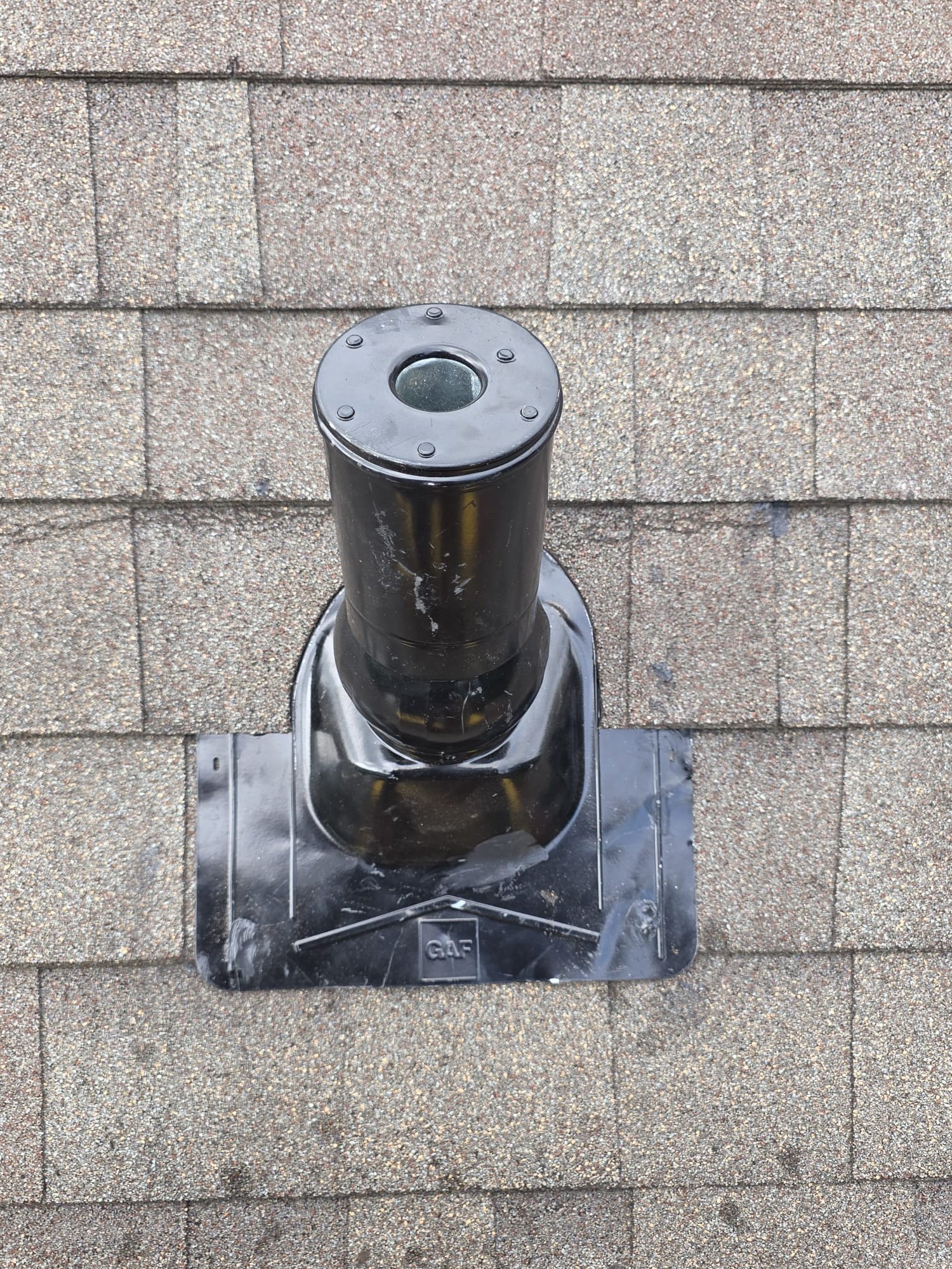 A newer roof boot installed around a roof vent pipe