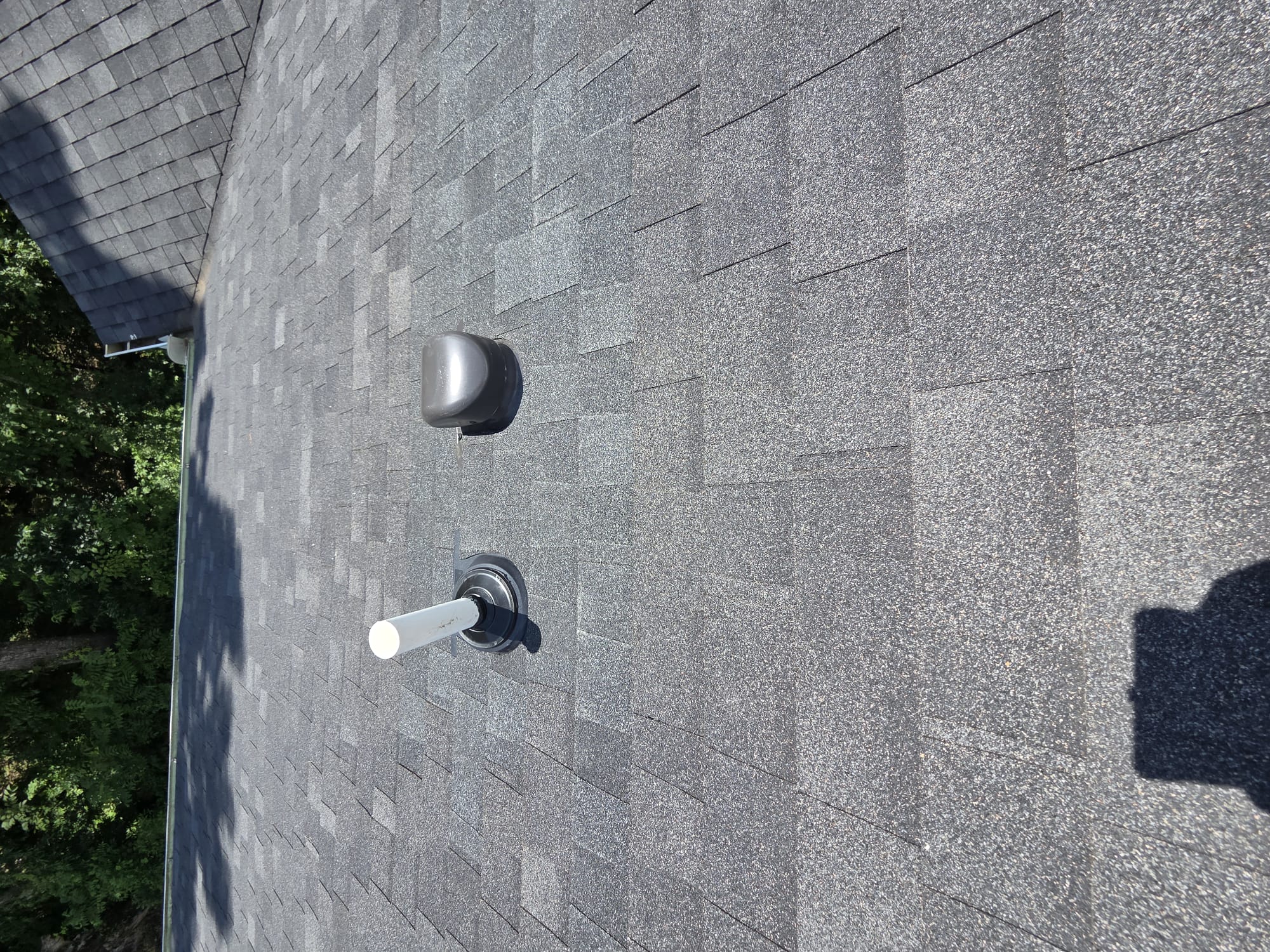 Finished roof vent detail on a shingled roof