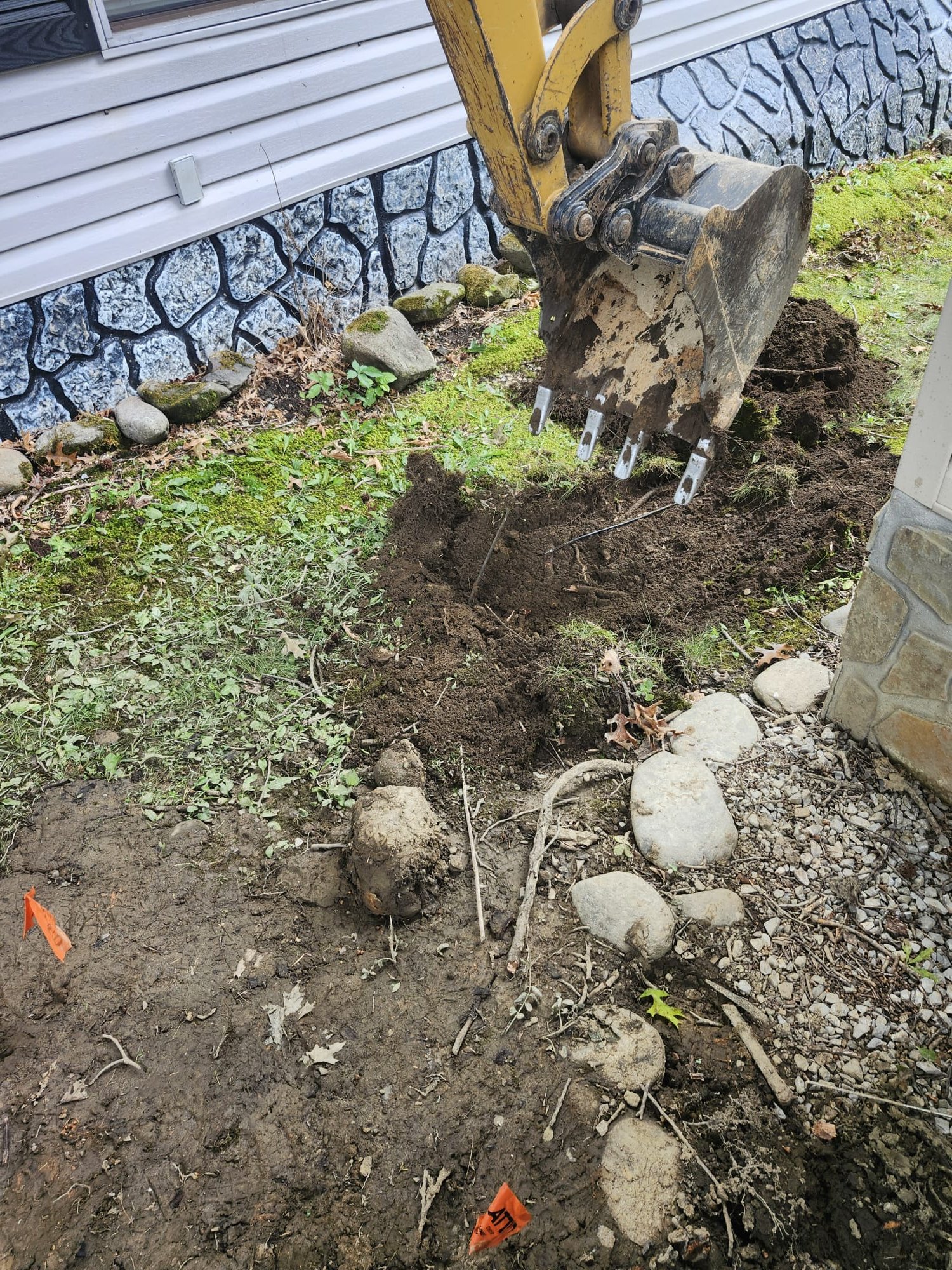 Excavation area opened near a home for underground water line work