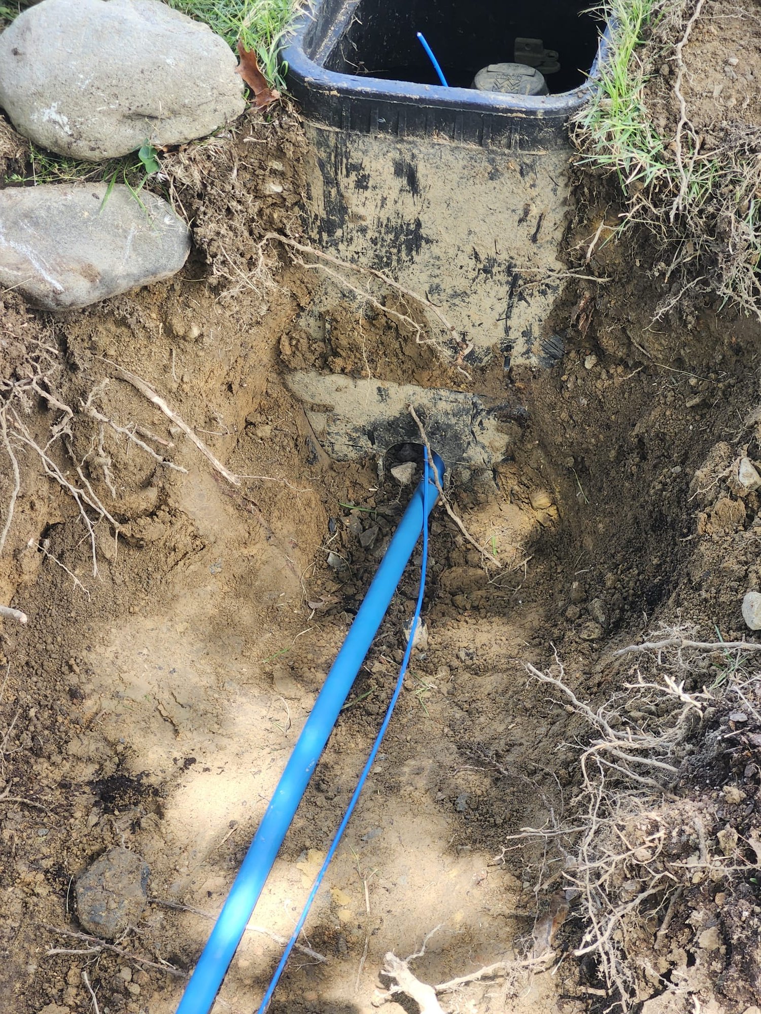 A new water service line routed into an underground meter box