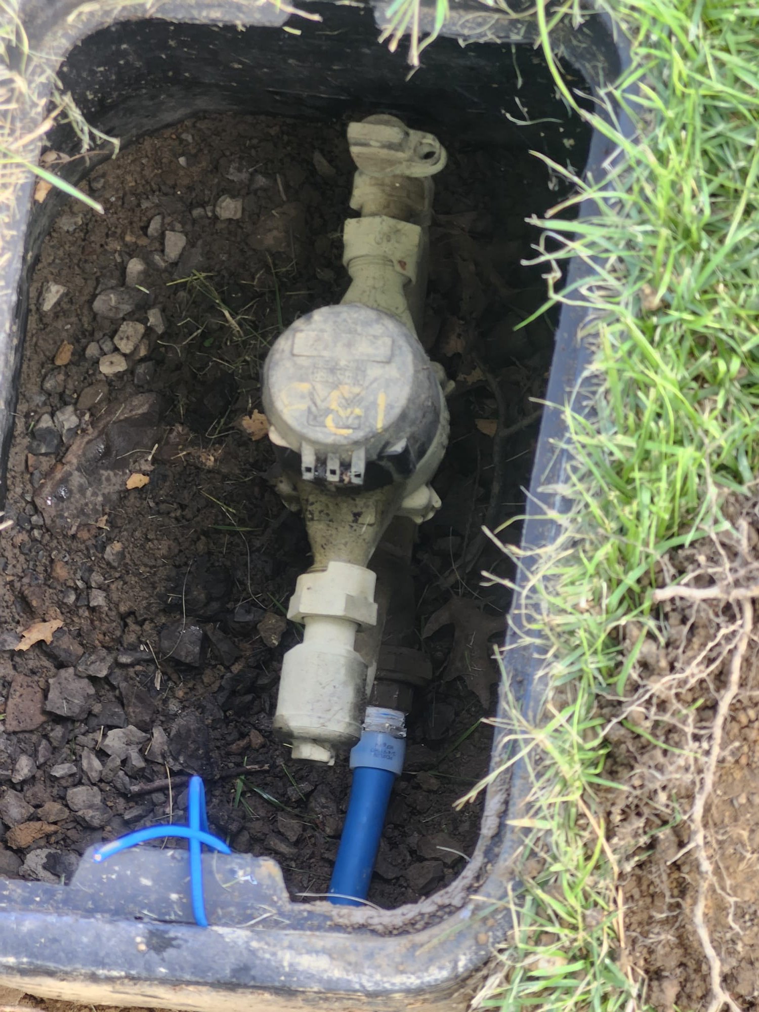 A new blue pipe connected to an underground water system