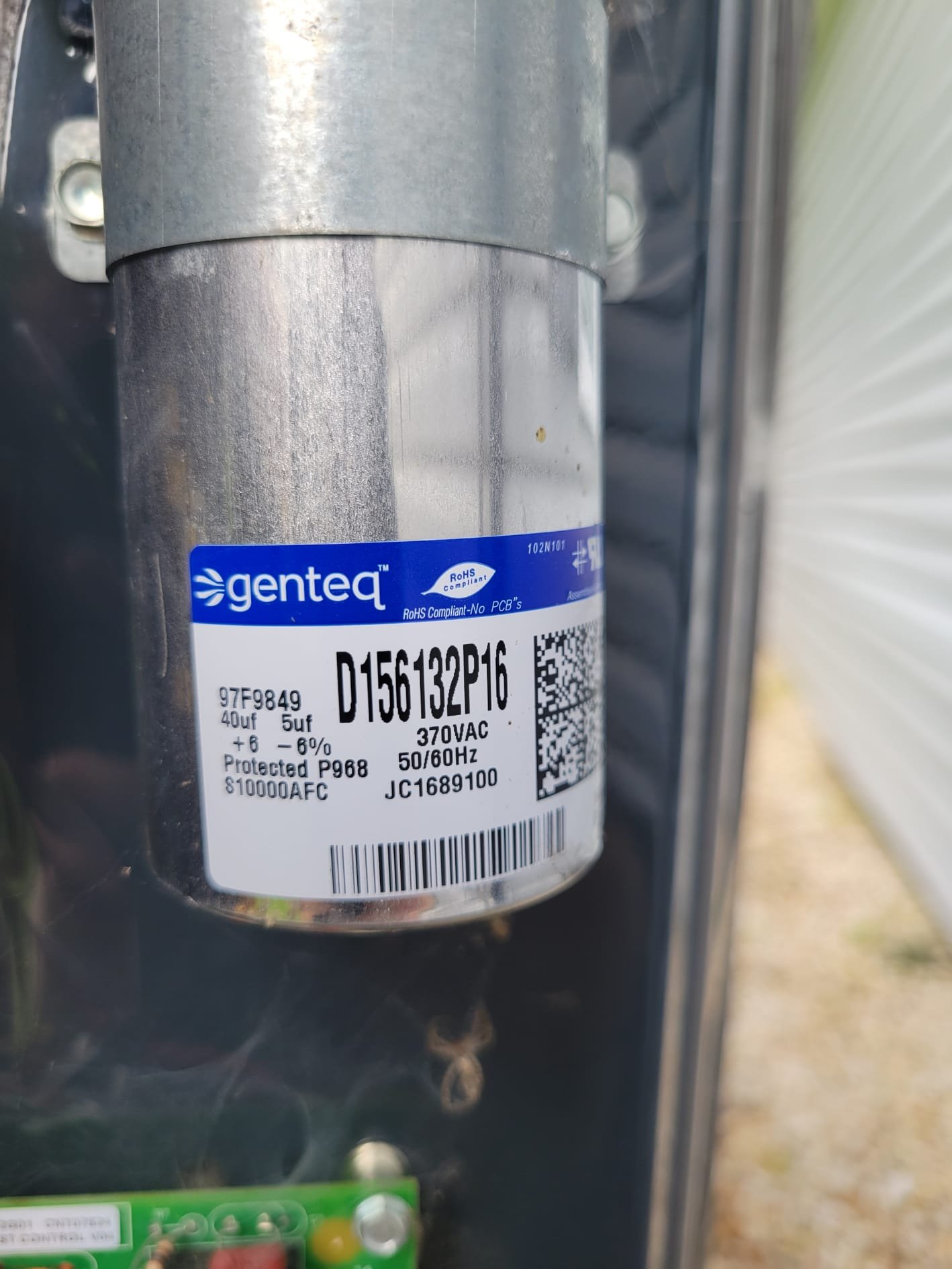 A newly installed capacitor in good condition inside an HVAC unit