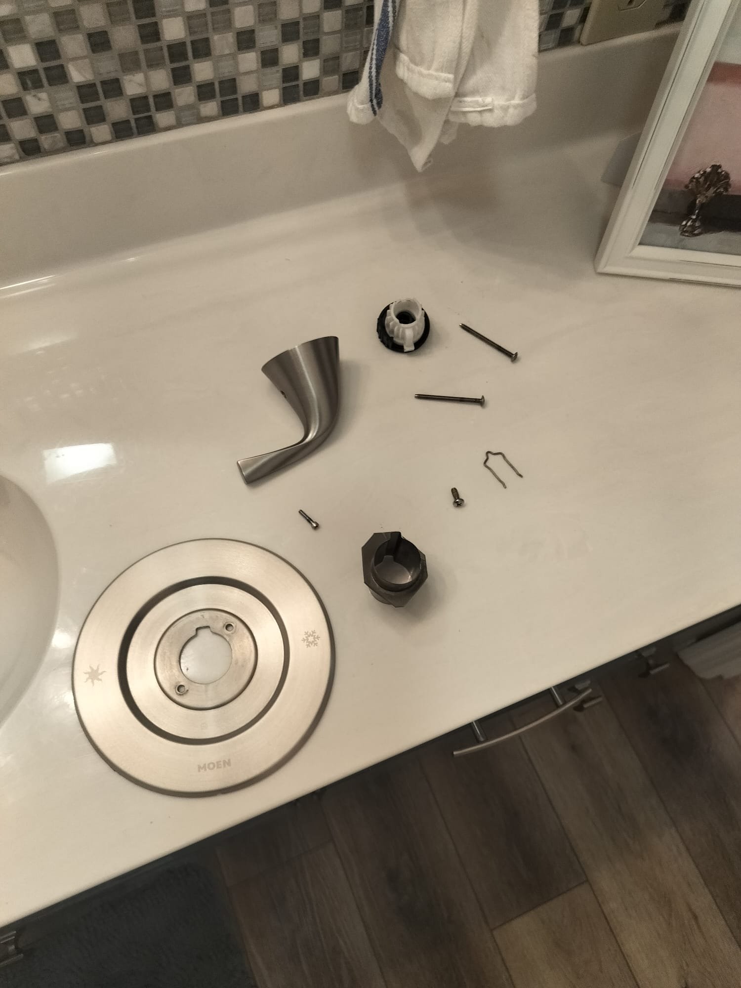 Shower handle parts laid out during a repair visit