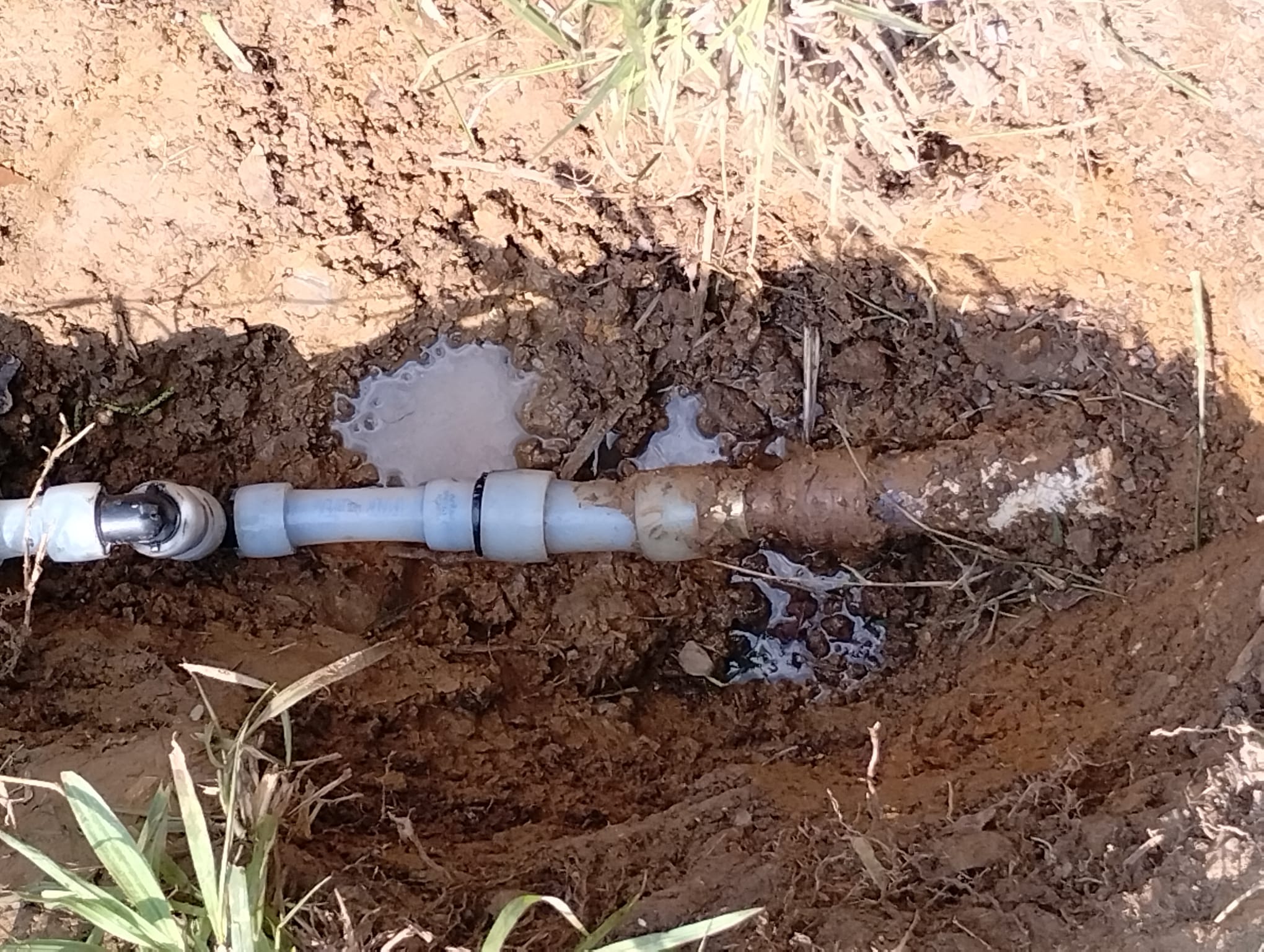 New PVC pipe and fittings installed in the trench before the area is closed back up