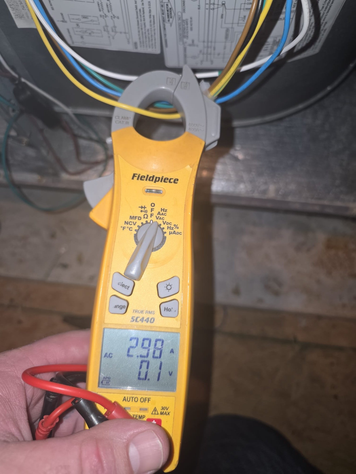 HEP technician checking electrical performance during HVAC service