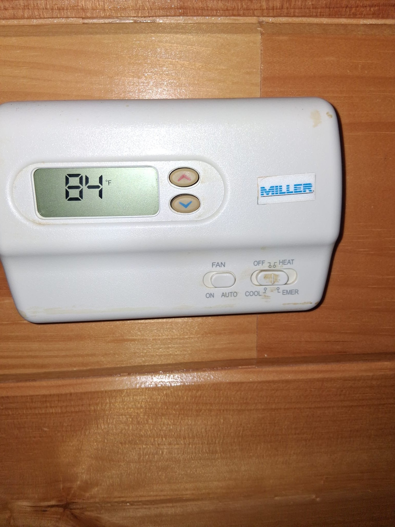 An older thermostat showing a home that is much warmer than expected.