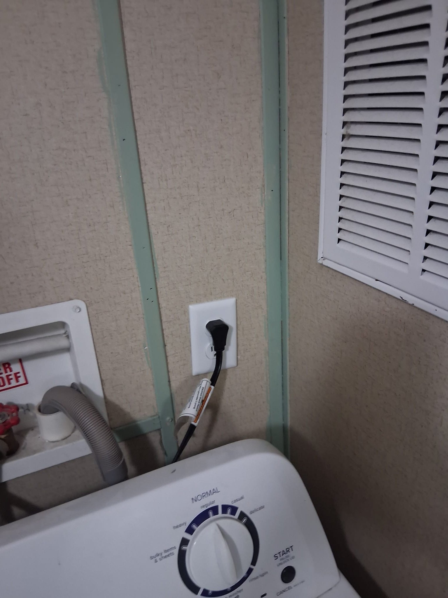 Completed laundry outlet with appliance plugged in
