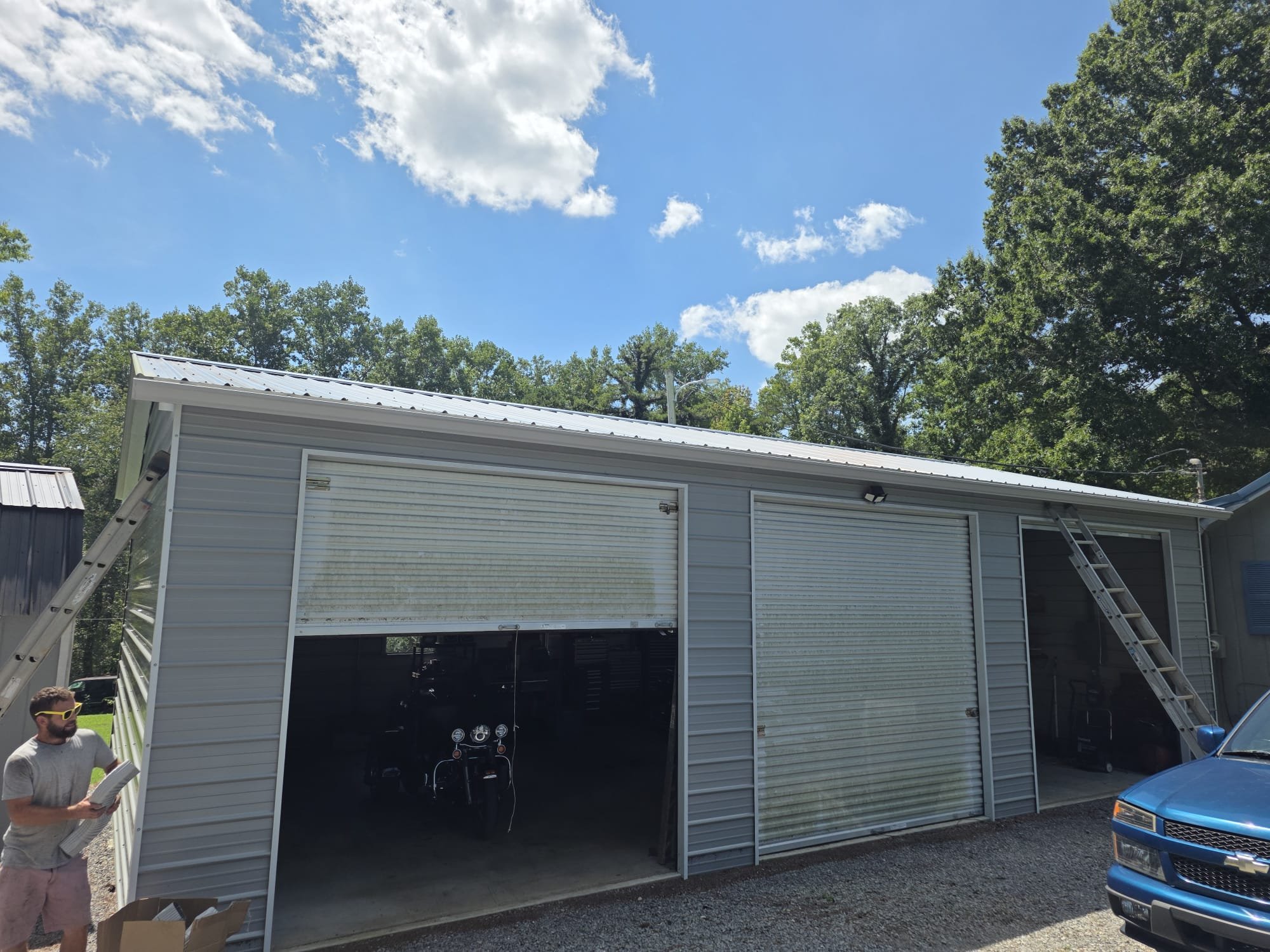 A recently installed metal roof on a detached building, showing a finished exterior upgrade