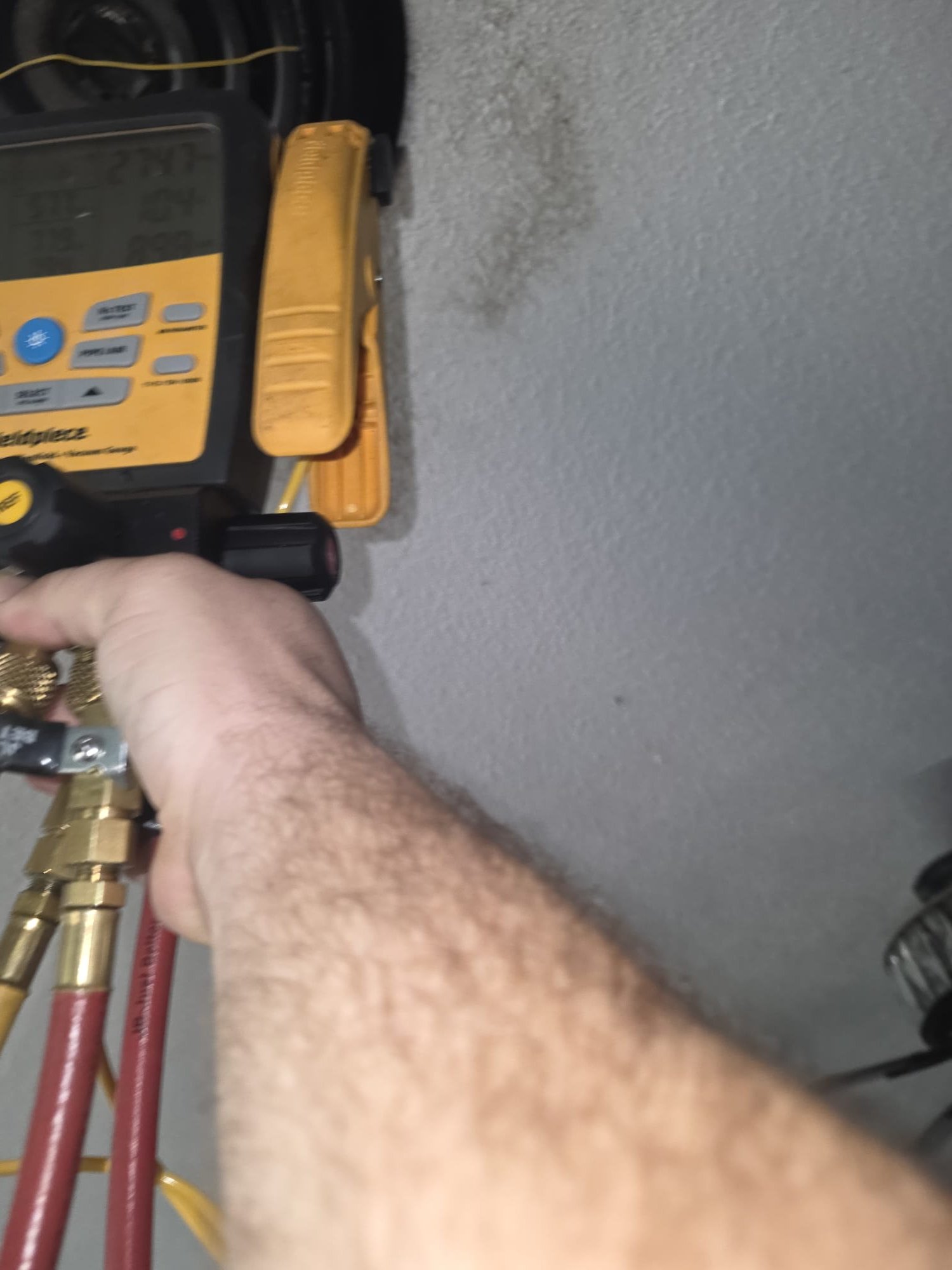 HVAC gauges connected during a service check