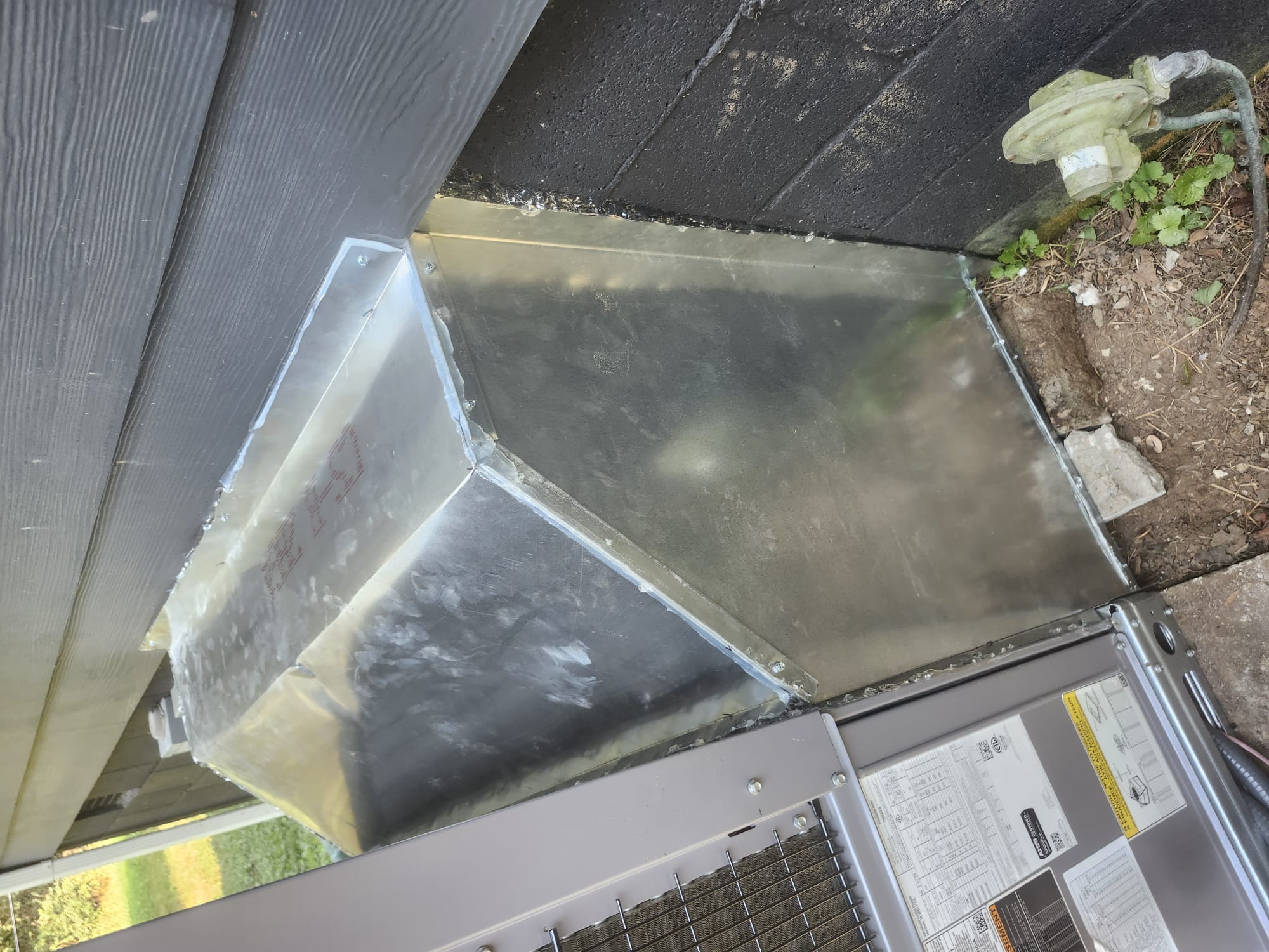 New exterior duct connection installed during HVAC work