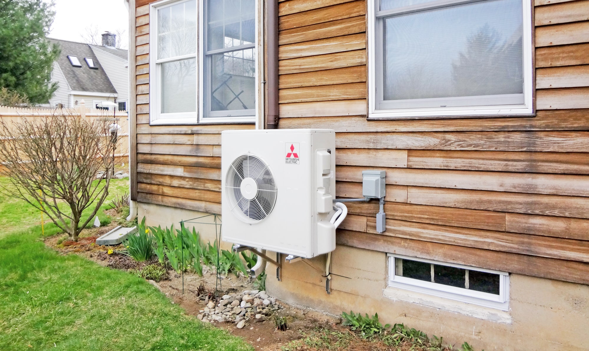 heat pump system on exterior wall of house
