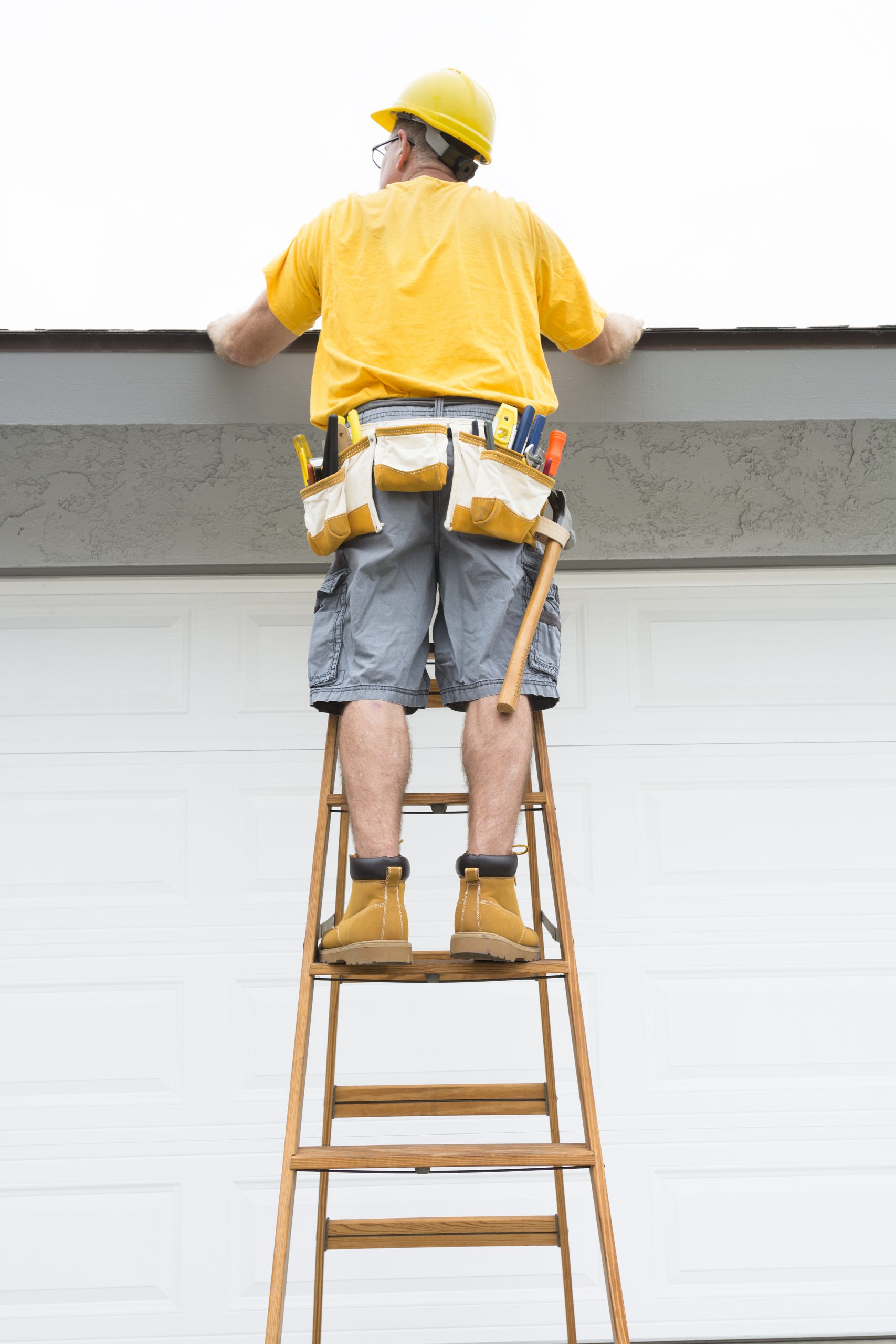 knoxville professional roofing contractor standing on a ladder