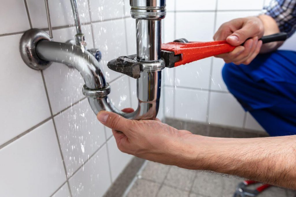 plumbing contractor repairing water leak in shower