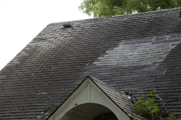 residential shingle roof in need of repair